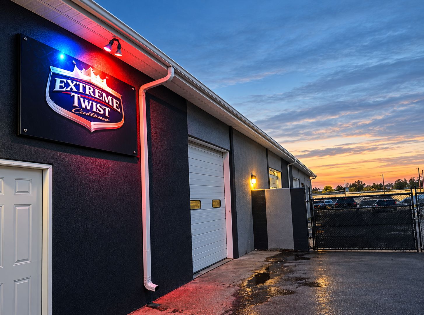Lit sign outside Extreme Twist Collision auto body shop on Caja Del Oro Grant Rd off Agua Fria in Santa Fe, New Mexico at dusk