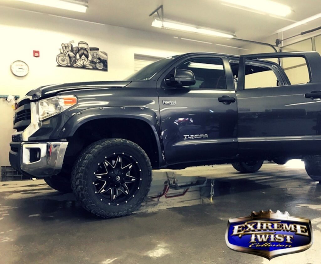 Black Toyota Tundra in the shop for body and paint work at Extreme Twist Collision in Santa Fe, New Mexico